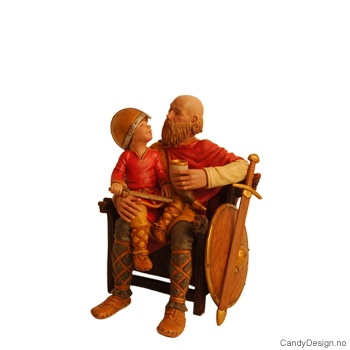 Viking far sittende på tronstol med gutt med hjelm og sverd på fanget  medium i farger